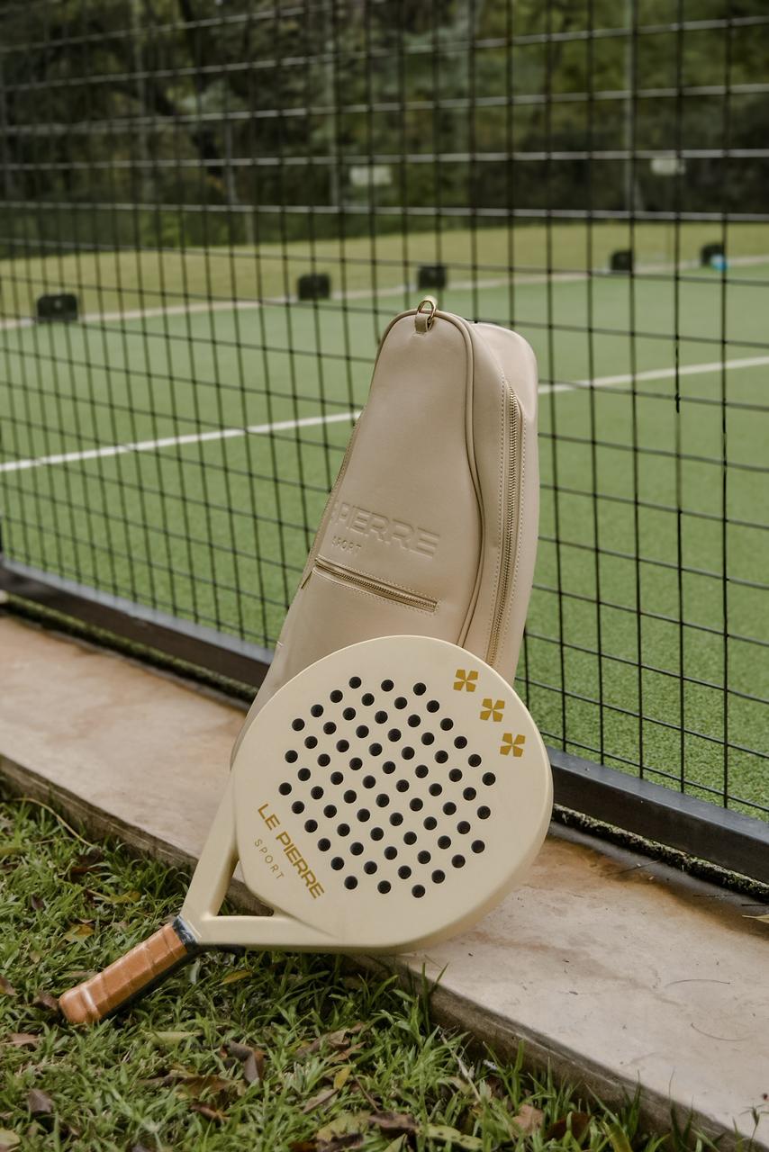 Le Pierre Sport bag and racket standing at the padel fence