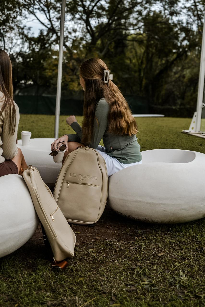 Le Pierre Sport bags resting beside a court lounge